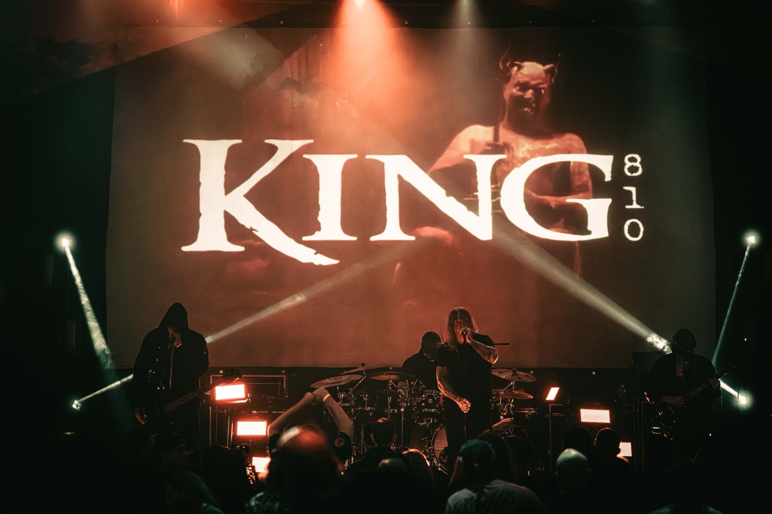 KING 810 / 2026 — Full band on stage beneath the KING 810 backdrop